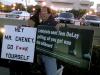 Lyn and Philip hold signs in protest